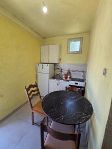 a small kitchen with a table and a counter top at Maki 4 in Radanovići