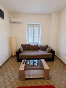 a living room with a couch and a coffee table at Maki 4 in Radanovići