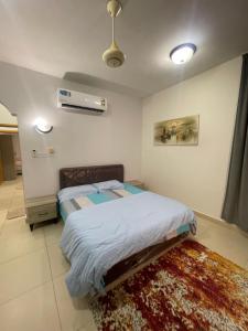 a bedroom with a bed and a rug at Adheeiz beach in Salalah