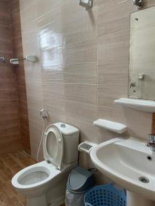 a bathroom with a toilet and a sink at Adheeiz beach in Salalah +8 photos