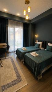 a hotel room with two beds with towels on them at Sheki Secret Garden Boutique Hotel & Guest House in Sheki