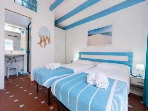 a bedroom with two beds with towels on them at Sweet home Santa Lucia in Santa Lucia +13 photos