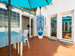 a room with a table and a surfboard at Sweet home Santa Lucia in Santa Lucia