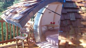 a tent on a deck with a chair in it at lov nid in Apt
