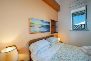 a bedroom with a bed and a painting on the wall at Sogno Blu in Furore
