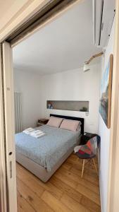 a small bedroom with a bed and a chair at Bella Vista Città Vecchia in Polignano a Mare