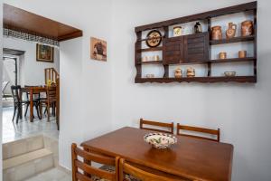 a dining room with a wooden table and chairs at IOANNAS ARCH HOUSE a in Gennadi +10 photos
