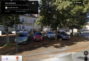 a group of cars parked in a parking lot at Au 15 - Charmant Studio hyper centre in Saint-Amand-Montrond