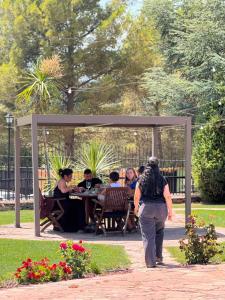 a group of people sitting at a table in a park at The Pines Hotel in Culla