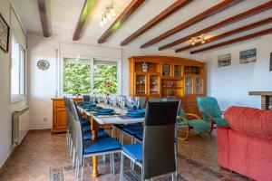 a dining room with a long table and chairs at Villa Panoramic in Santa Susanna