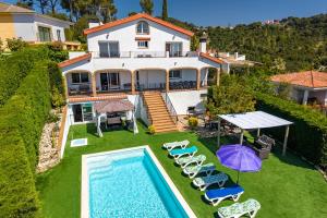 an aerial view of a house with a swimming pool at Villa Panoramic in Santa Susanna