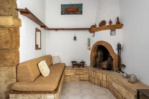 a living room with a couch and a fireplace at IOANNAS ARCH HOUSE a in Gennadi