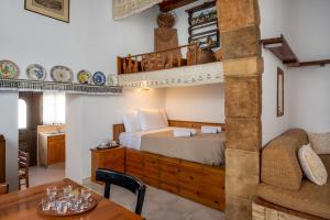 a bedroom with a bed with a loft at IOANNAS ARCH HOUSE a in Gennadi