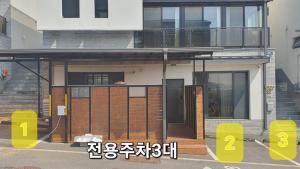 a house with wooden doors and a balcony at Paju Byeol-bom in Paju