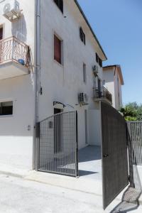 a gate in front of a white building at Mara's home in San Salvo