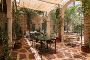 a patio with a table and chairs and plants at Sel d Ailleurs, Ouirgan - adults only in Ouirgane