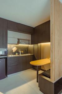 a kitchen with wooden cabinets and a wooden table at Elegante estudio in Buenos Aires