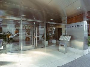 a glass building with a bench in front of it at Elegante estudio in Buenos Aires +79 photos