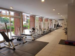 a gym with a row of treadmills and machines at Elegante estudio in Buenos Aires