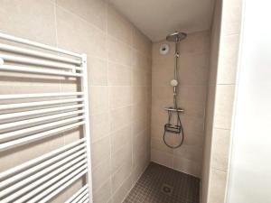 a shower with a shower head in a bathroom at La Perle bleue in Berck-sur-Mer