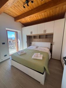 a bedroom with a large bed with a wooden ceiling at Il Nespolo in Celano