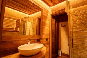 a bathroom with a white sink and a mirror at Casa Lotre in Pragelato