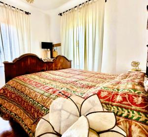 a bedroom with a large bed with a redspread at Domus Dafne Apartment in Senigallia