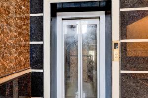 a door with a glass window on a building at Hotel O BAL GOPAL in Delhi