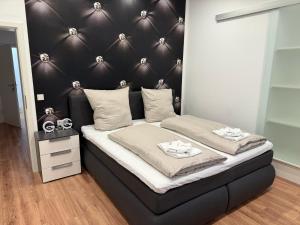 a bedroom with a bed with a black headboard at Casa del Mondo 1 in Sankt Aldegund