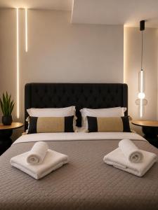 a bedroom with a large bed with two towels on it at Cabana Condo in Ierapetra