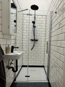 a bathroom with a shower and a sink at Bauhaus Suite Dessau in Dessau +54 photos