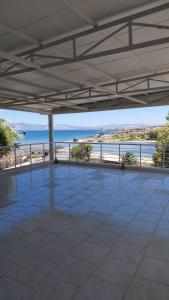 an empty patio with a view of the ocean at Begonvil Otel in Emin Sitesi