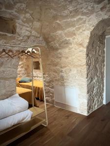 a bedroom with a bunk bed in a stone wall at Al Settimo Chilometro in Gioia del Colle +32 photos