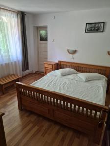 a bedroom with a large bed and a wooden floor at VILA SZOKE SOVATA in Sovata +23 photos