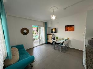 ein Wohnzimmer mit einem blauen Sofa und einem Tisch in der Unterkunft Elfida Apart in Datca