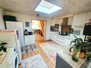 a kitchen with a refrigerator and a stove top oven at Tomorrowland in Rumst