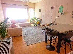 a living room with a couch and a table at Tomorrowland in Rumst +6 photos