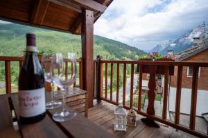 a bottle of wine sitting on a table on a balcony at Casa Lotre in Pragelato +6 photos