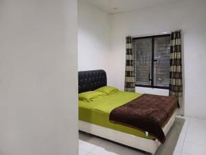 a bedroom with a bed and a window at Villa GreenHill A1 SibolangitView in Bandarbaru +11 photos