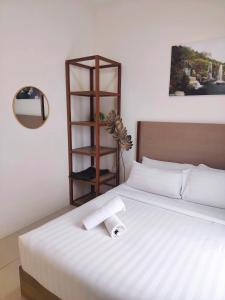 a bedroom with a bed with a towel on it at Swiss Garden resort residence by Moonlight in Kuantan +29 photos