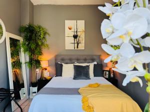 a bedroom with a bed with white flowers at Polly's Home Boutique GuestHouse & Private Suites in Aralias in Puerto Vallarta