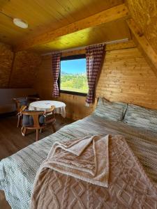 a bedroom with a bed in a log cabin at Mountain peaceful cottages in Žabljak