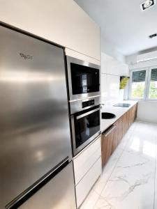a kitchen with a stainless steel refrigerator at FORUM Square in Skopje