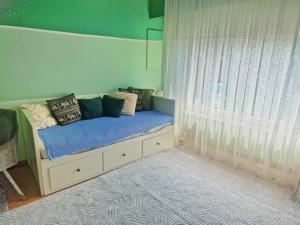 a bedroom with a bed with pillows and a window at Tomorrowland in Rumst