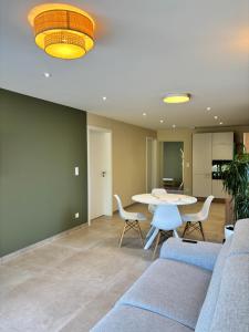 a living room with a couch and a table at La Loge des Deux Sapins in Oberbetschdorf +14 photos