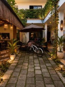 a bike parked in front of a building with an umbrella at Grande Maldives Inn in Himmafushi
