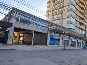 an empty street in front of a building at Dpto vista hermosa in Osorno