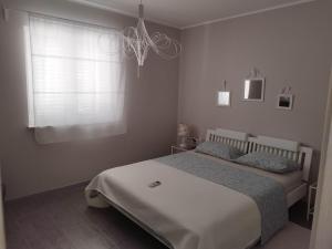 a bedroom with a bed and a window at Holiday house Altea , Barbat on the Island Rab in Rab
