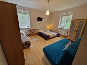 a bedroom with a bed and a table and chairs at CasaBlanca Biały Dom in Borne Sulinowo +16 photos