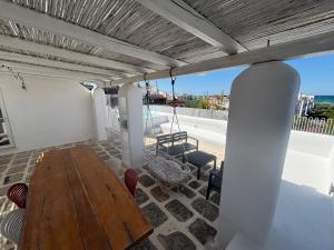 a patio with a wooden table and chairs on a roof at Casa Mediterranea al mare, Jacuzzi, Torre Guaceto, Ostuni in Specchiolla +54 photos